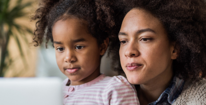 Mother with daughter looking at computer